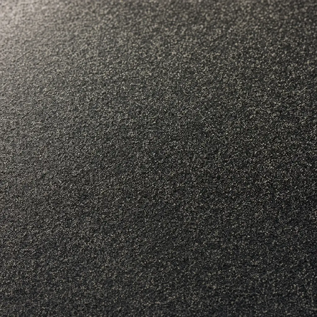 Close-up of a black asphalt back coating dusted with fine sand